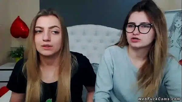 Two brunette amateur teen lesbian hotties stripping and tying in bed then licking in their private live webcam show on homemade footage